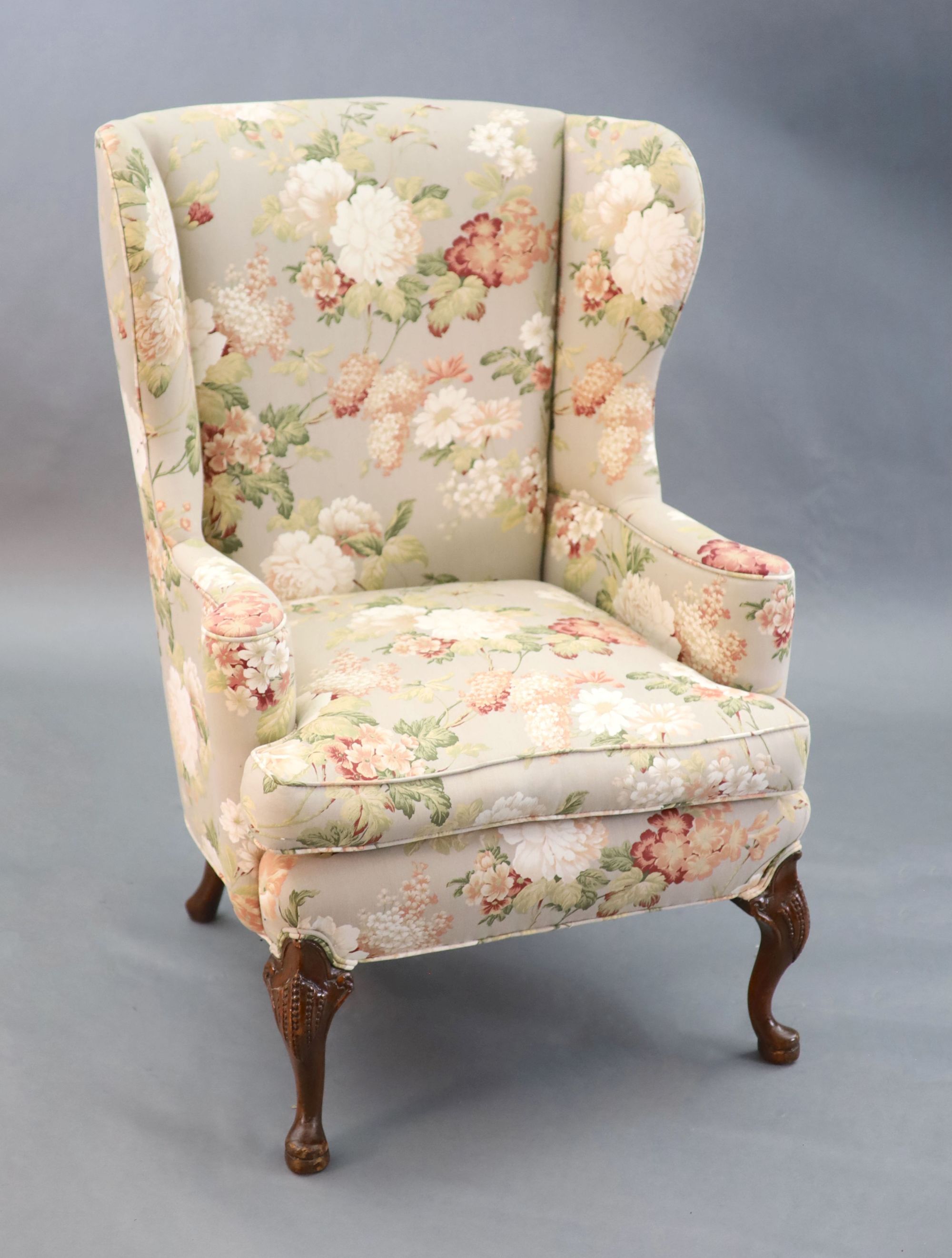 A French Hepplewhite style wing armchair together with a matching contemporary footstool